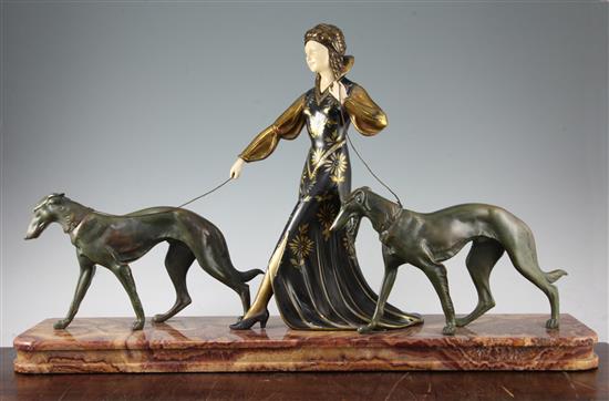 A French Art Deco figure group modelled as a stylish woman walking with two Borzois, 31in.